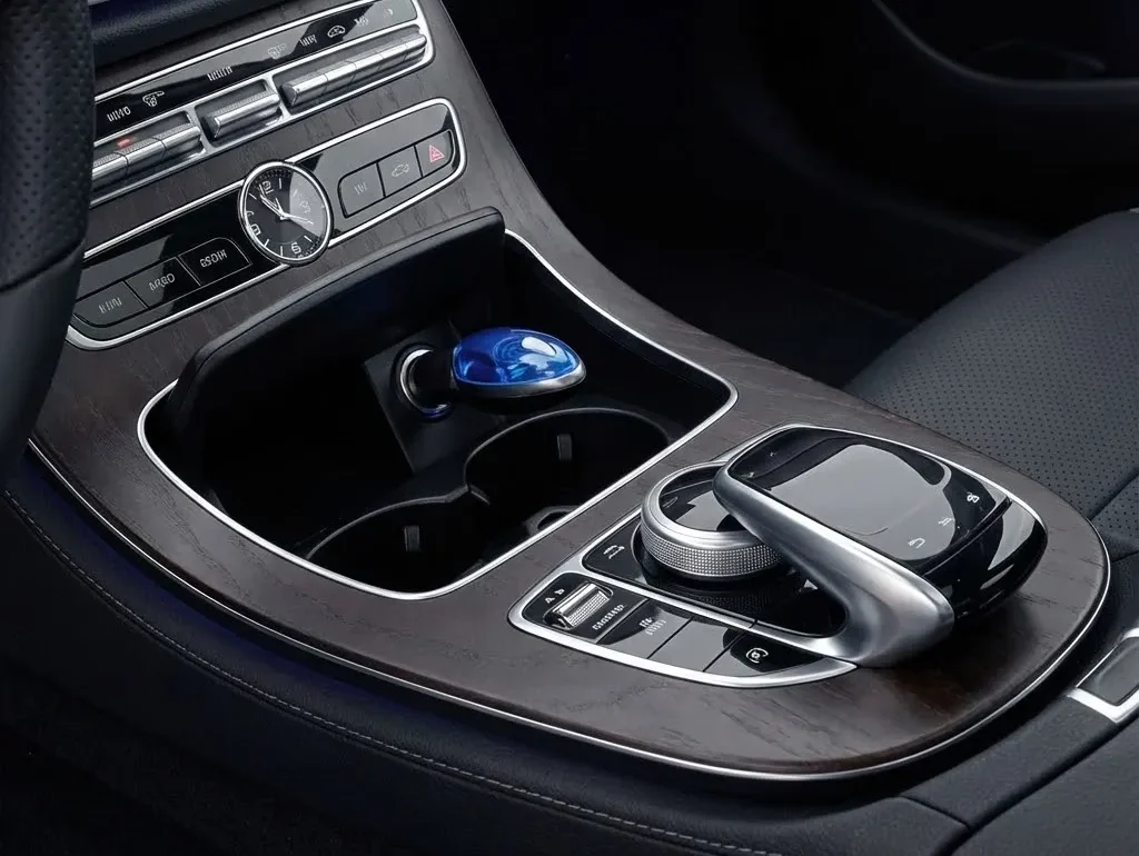 Hand holding the compact FuelSync fuel-saving device.